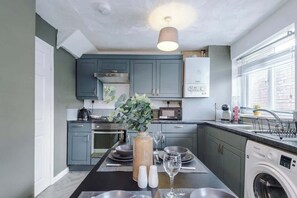 Enjoy cooking in this well-equipped kitchen with a central island and appliances.