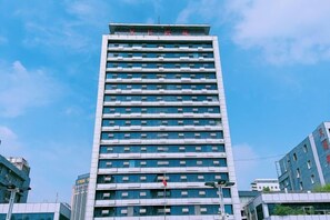A multi-story building with a modern architectural design, featuring a series of windows and a flat roof. - Zhongyuan Dasha Business Hotel (Zhengzhou)