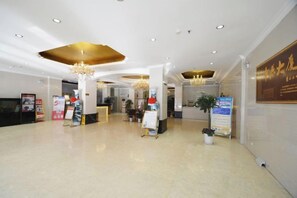 A spacious lobby with a reception desk, chandeliers, and informational posters. - Zhongyuan Dasha Business Hotel (Zhengzhou)