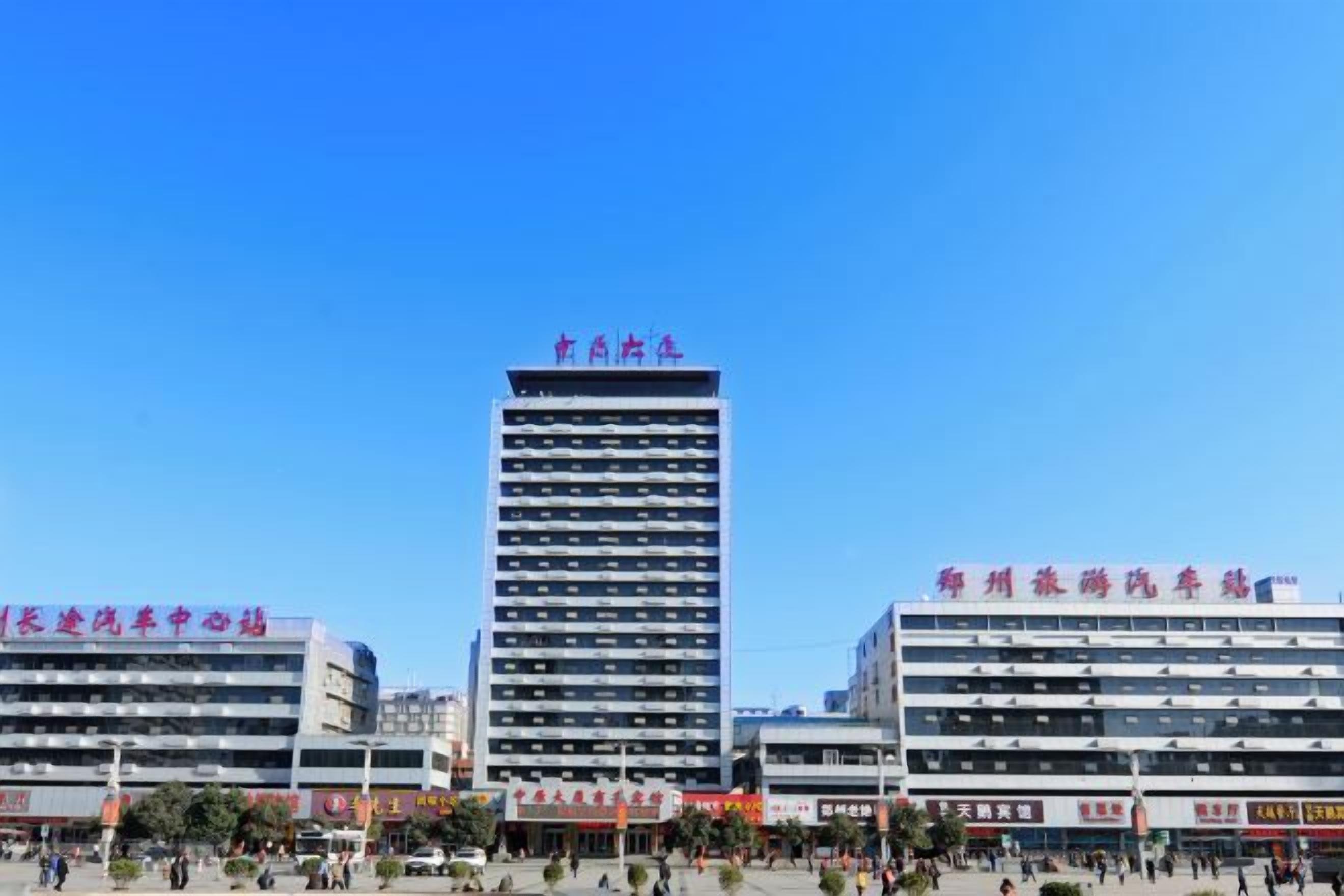 A multi-story building with signage indicating it is a hotel.