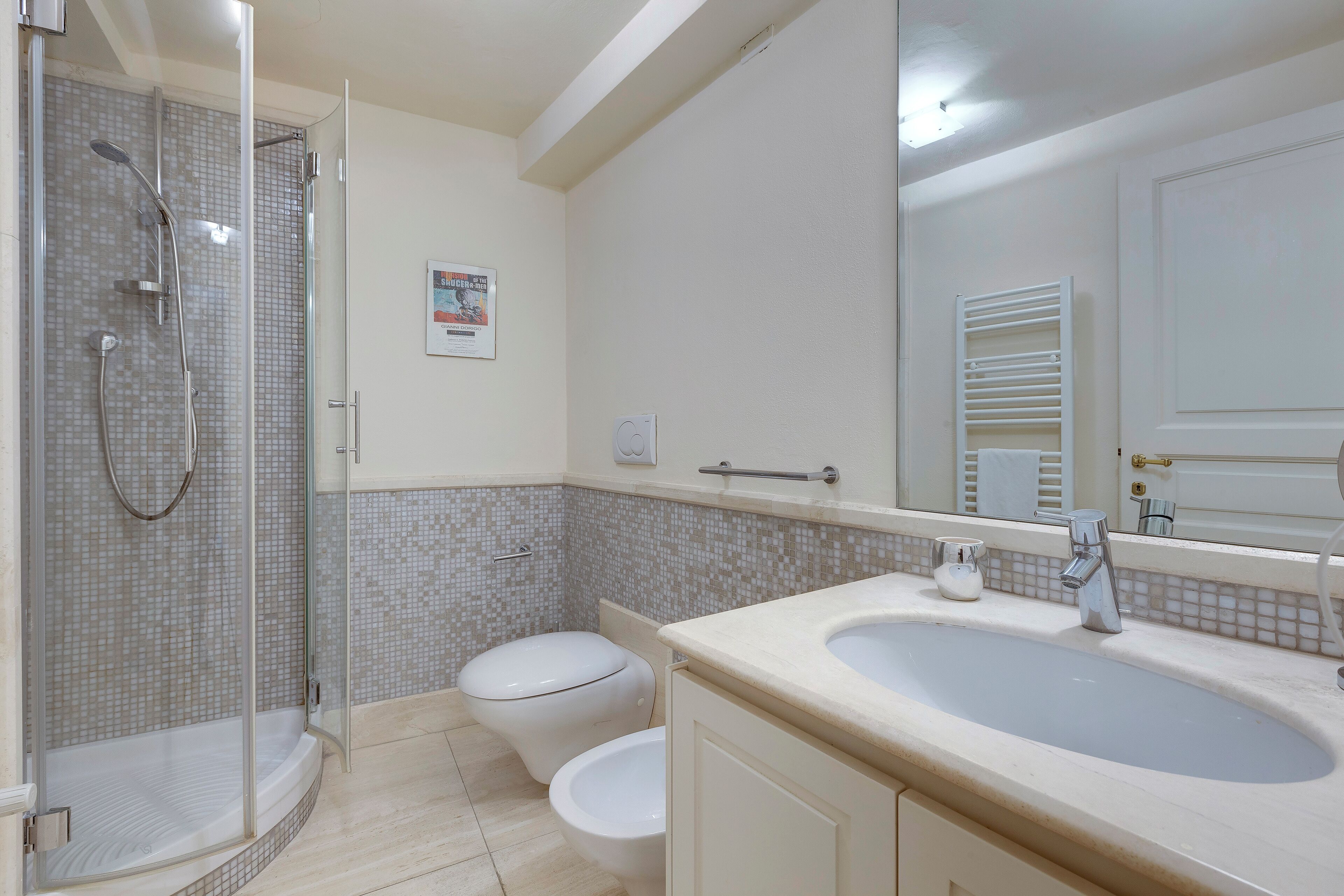 A bathroom with a shower, toilet, and sink.