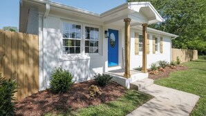 A single-story house with a white exterior, a blue door, and a covered porch. - Winchester TN lake house rental, Tims Ford Lake vacation home,private boat ramp (Winchester)
