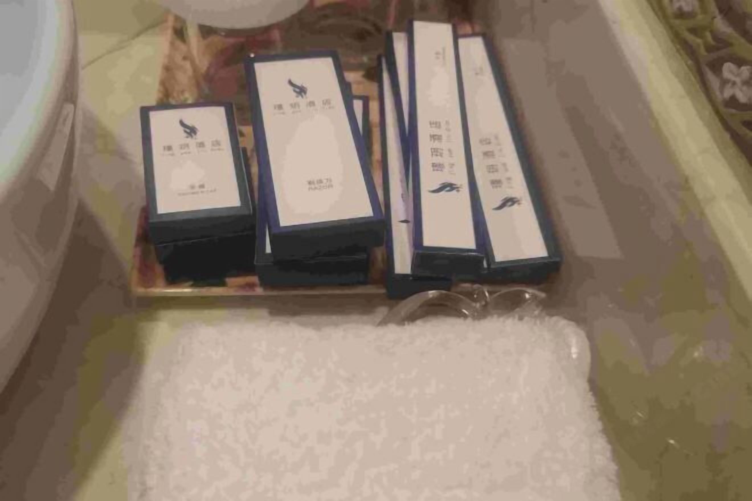 A series of rectangular boxes with labels, placed on a surface with a patterned background.