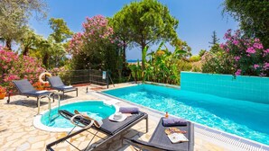 A swimming pool with lounge chairs, a small hot tub, and a view of the sea. - Villa Poseidonia - Three Bedroom Villa, Sleeps 6 (Ionian Islands)