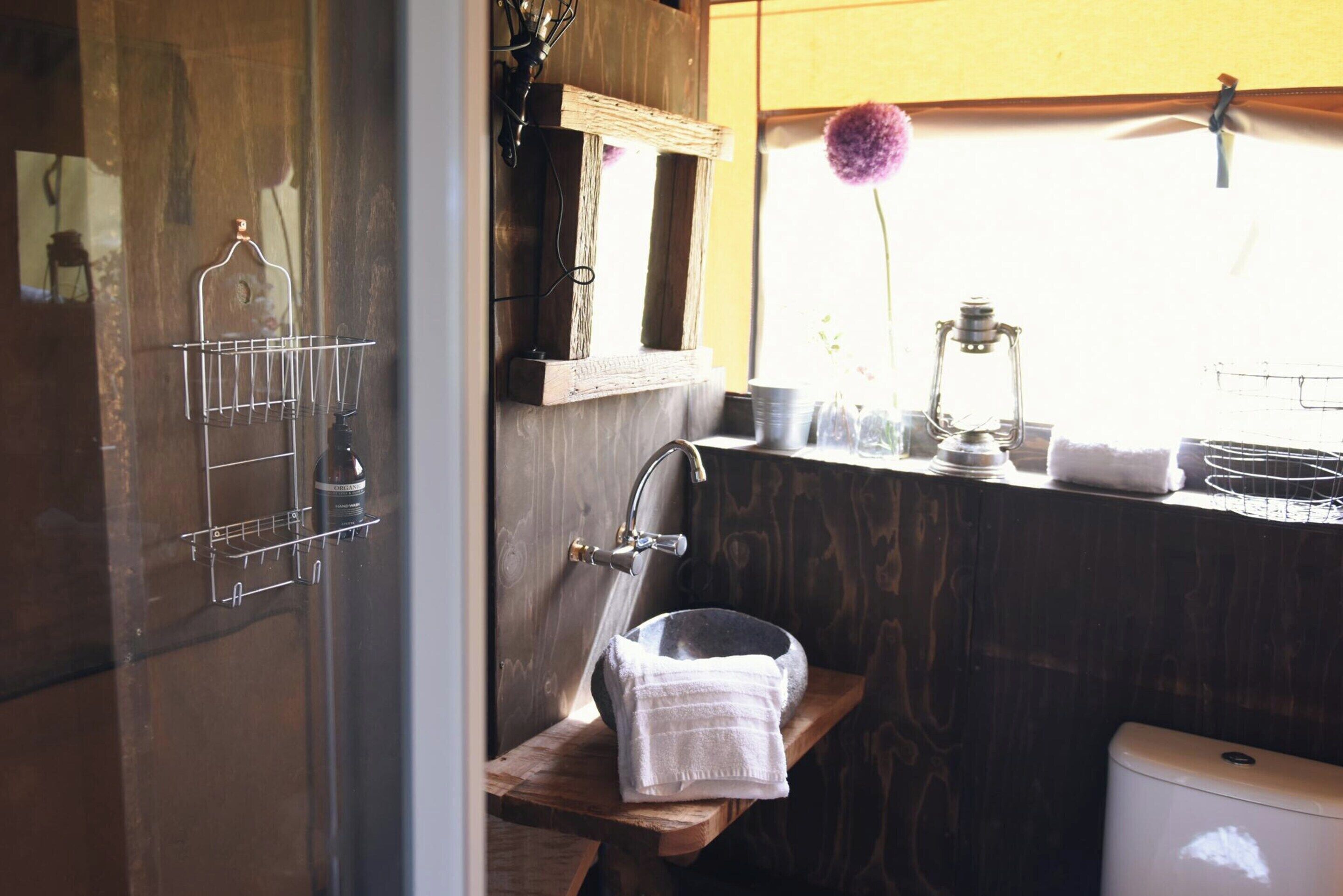 A bathroom with a wooden vanity, a sink, and a mirror.