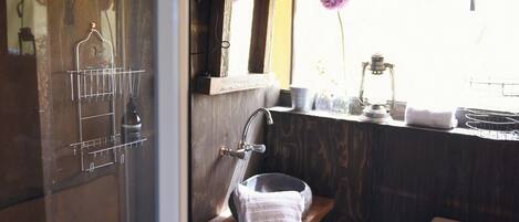 A bathroom with a wooden vanity, a sink, and a mirror.