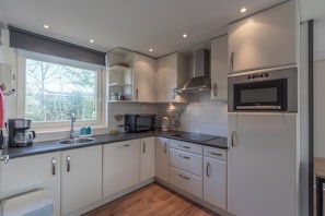 Bungalow | Private kitchen | Highchair - Bungalow With Sauna and Pool in Quiet Location (Sint Maartensvlotbrug)