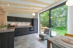 Bungalow | Private kitchen | Stovetop, electric kettle, toaster, highchair - Attractive Home With Terrace (Callantsoog)