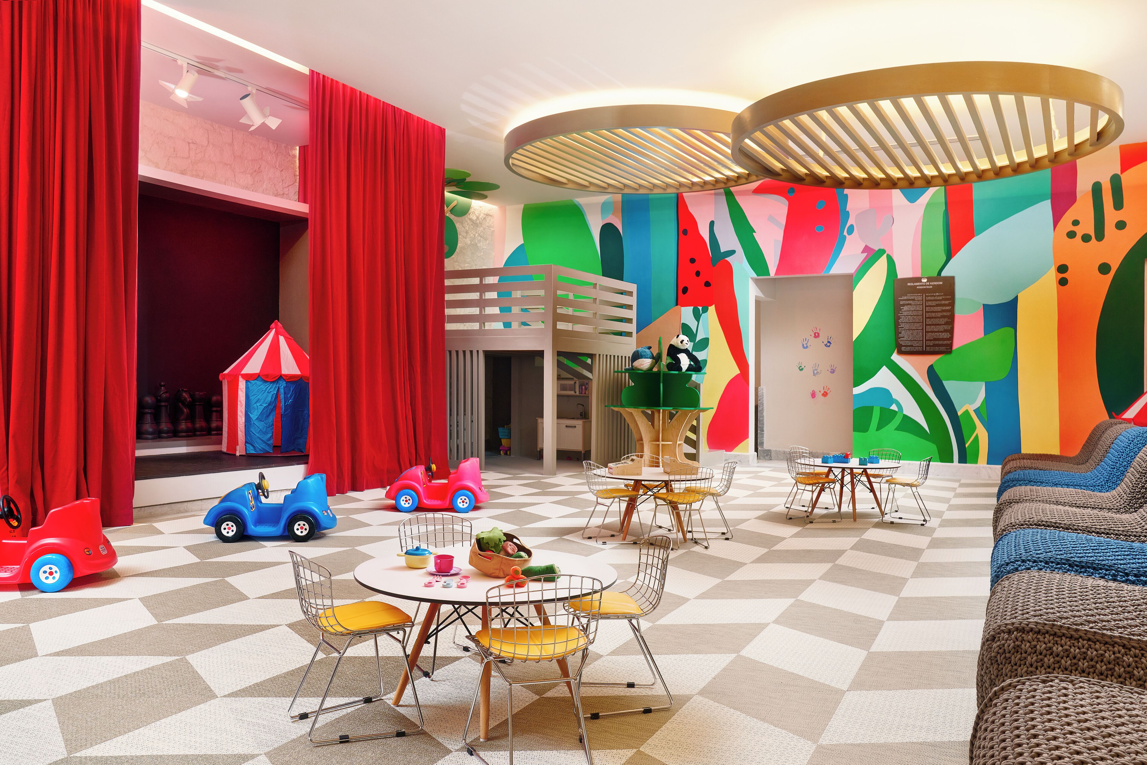 A children's playroom with a checkered floor, colorful walls, and a bunk bed.