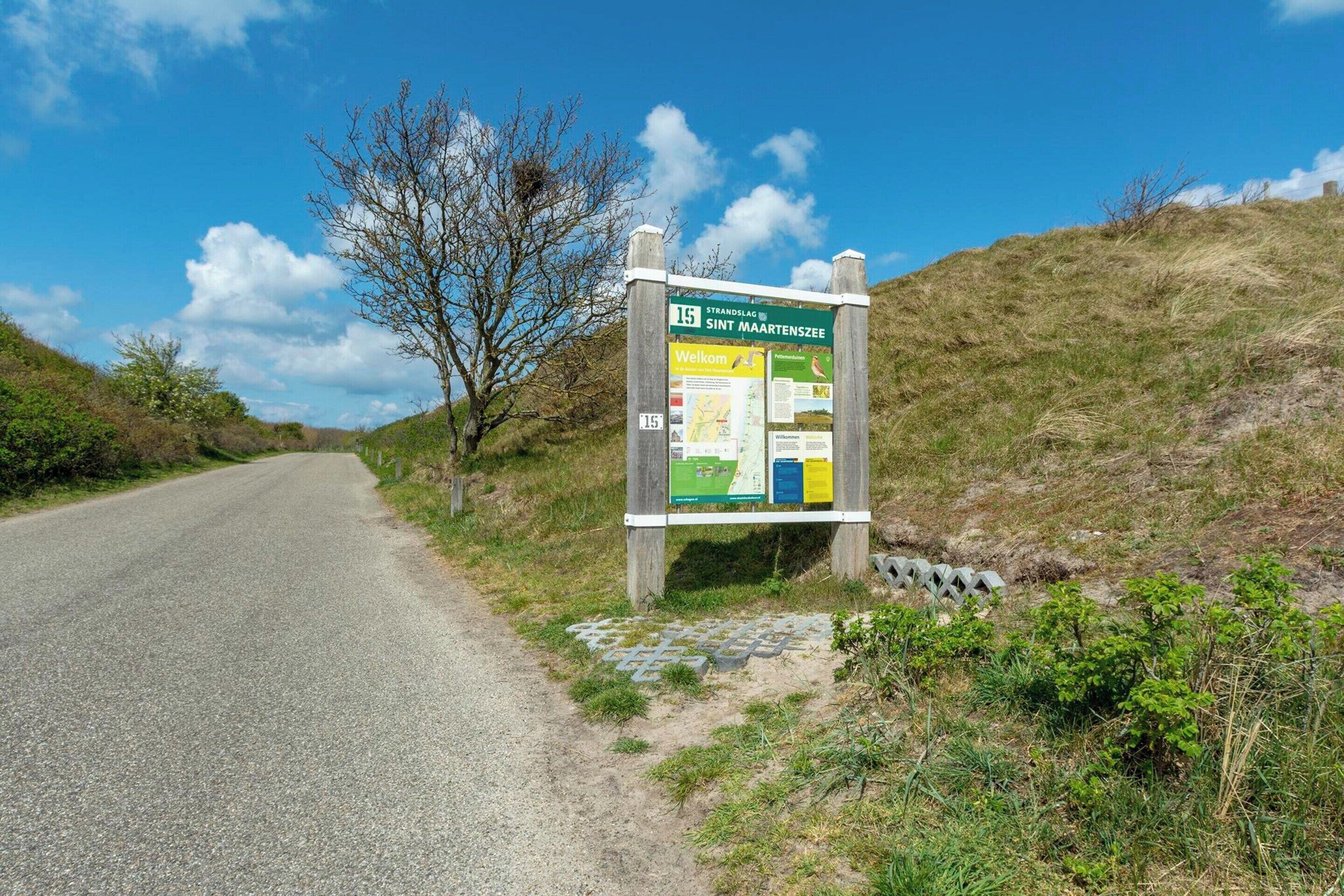 A signboard with information about Strandslag and SINT MAARTENSZEE.