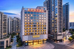 A multi-story hotel with a prominent entrance and a well-lit facade.