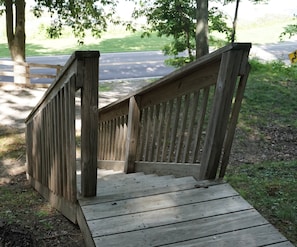 A wooden staircase with a handrail leading to a higher level.