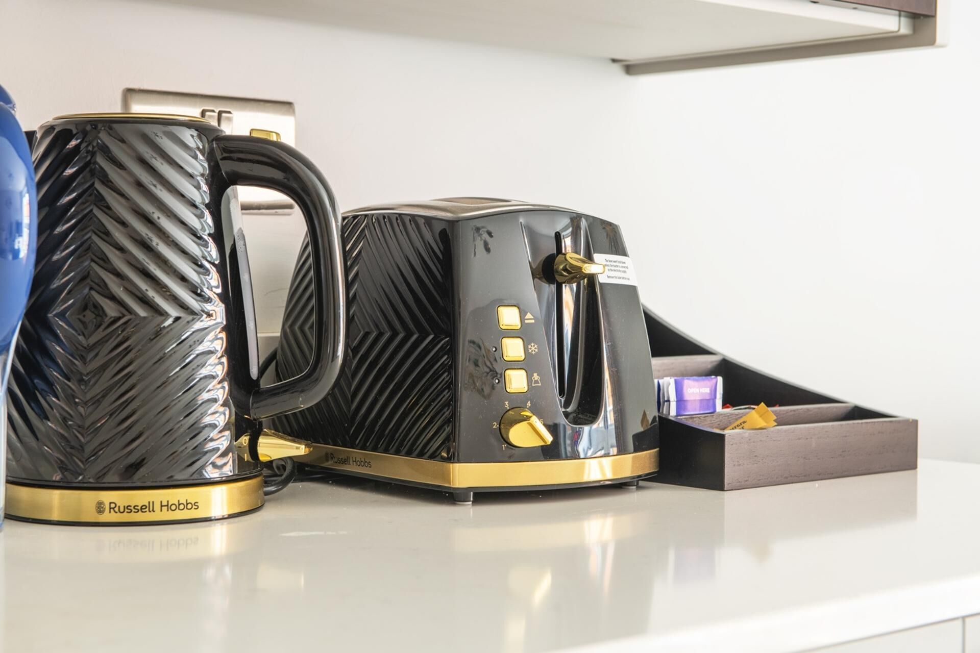 A coffee maker and a mug on a countertop.