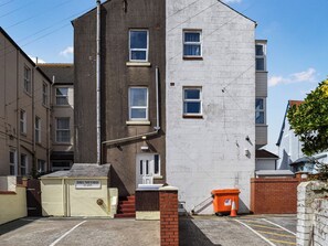 A multi-story building with a car park labeled 'DRUMFORD car park' and a red trash bin. - A spacious property perfect for families and friends. (Bispham, near Blackpool)