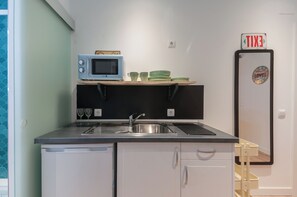 Equipped with a sink, microwave, and refrigerator, this kitchen offers everything you need for a comfortable stay.