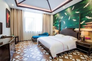 A hotel room with a large bed, a desk, a chair, and a patterned floor. - Yueyang Qingcheng Theme Hotel (Yueyang County)