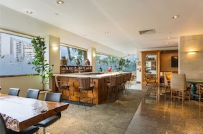 Relax in our spacious lobby with a central bar, seating area, and dining space, offering a view of the city.