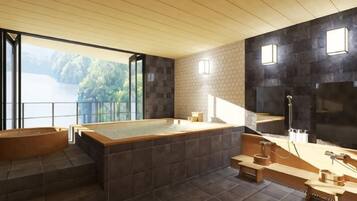 A modern bathroom with a large bathtub, a separate soaking tub, and a view of a lake.