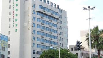 A multi-story building with a modern architectural design, featuring a series of windows and balconies.