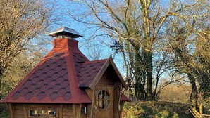 A small wooden cabin with a sloped roof, a front door, and a window. - Spacious dog-friendly cottage in an idyllic rural setting near amazing beaches (Boncath)
