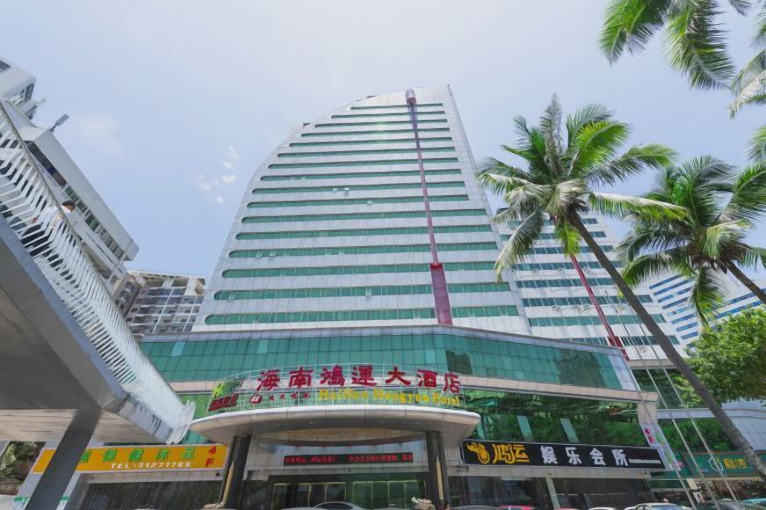 A high-rise hotel with a modern glass facade, multiple floors, and a prominent entrance.