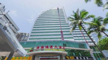 A high-rise hotel with a modern glass facade, multiple floors, and a prominent entrance.