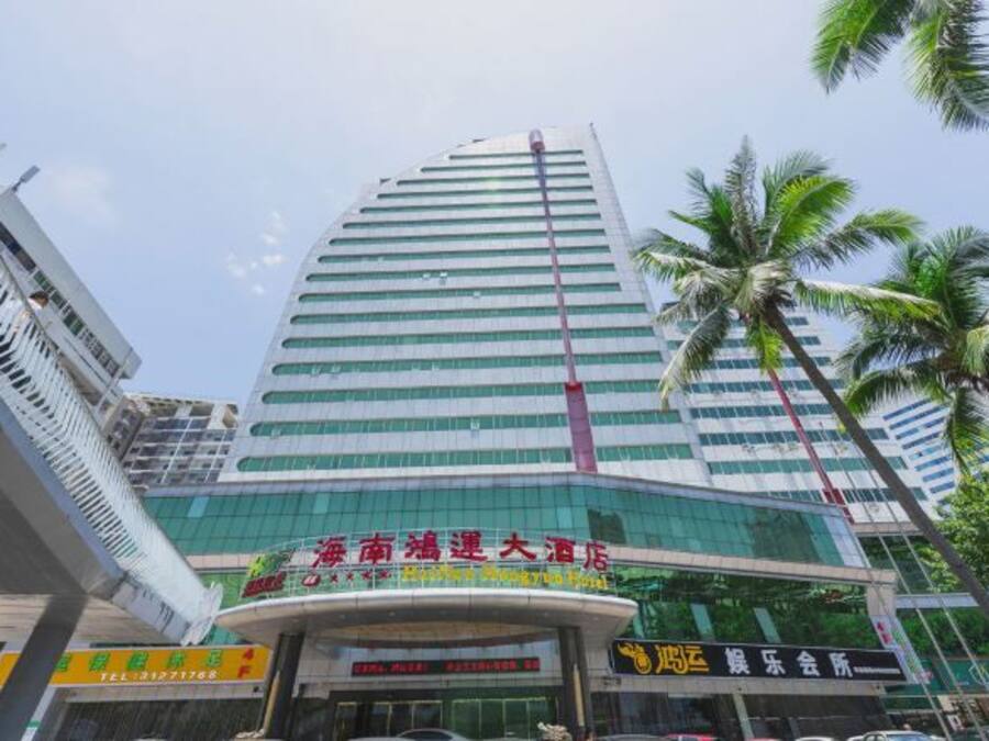 A high-rise hotel with a modern glass facade, multiple floors, and a prominent entrance.