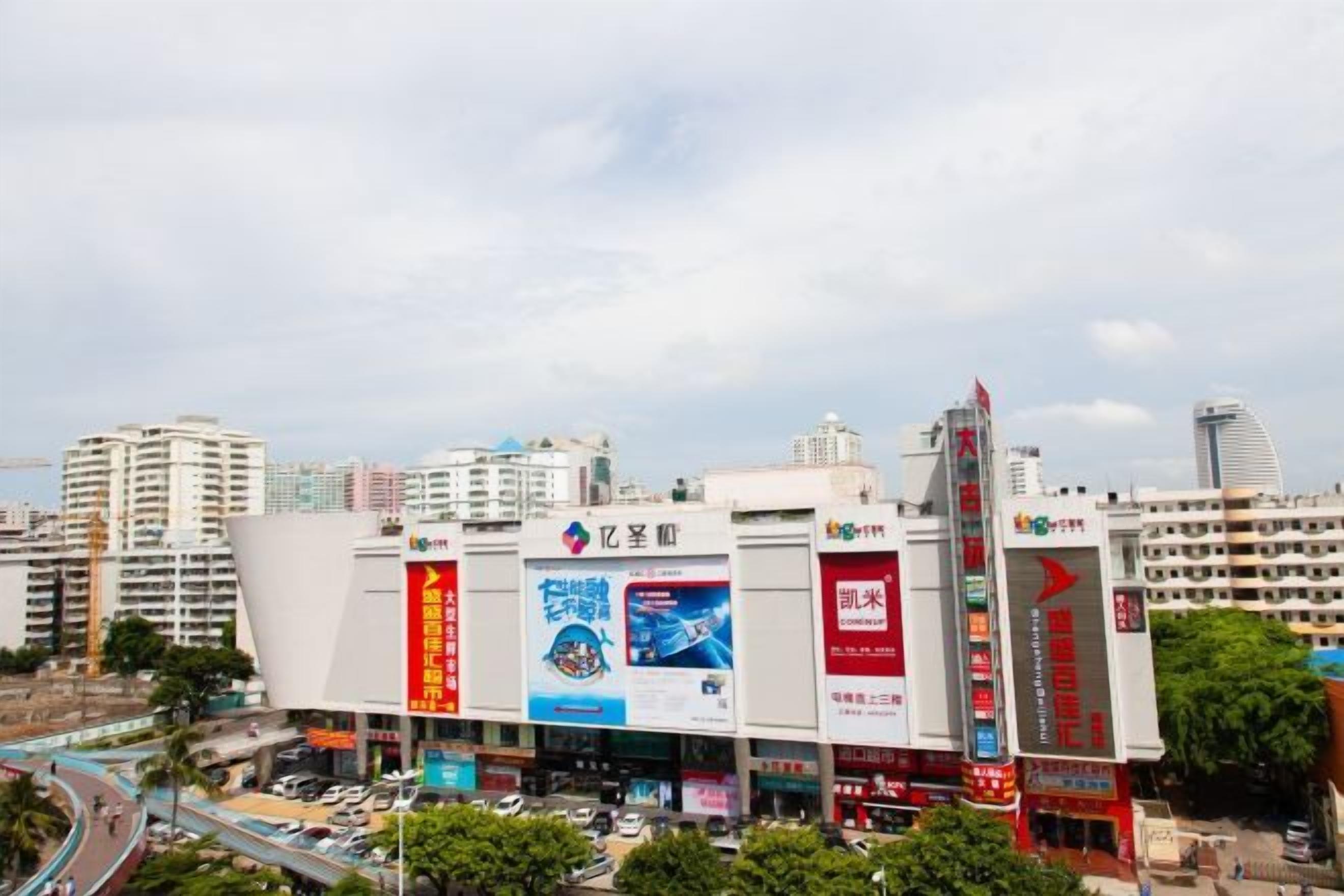 A large commercial building with multiple floors, prominent signage, and a busy street in the foreground.