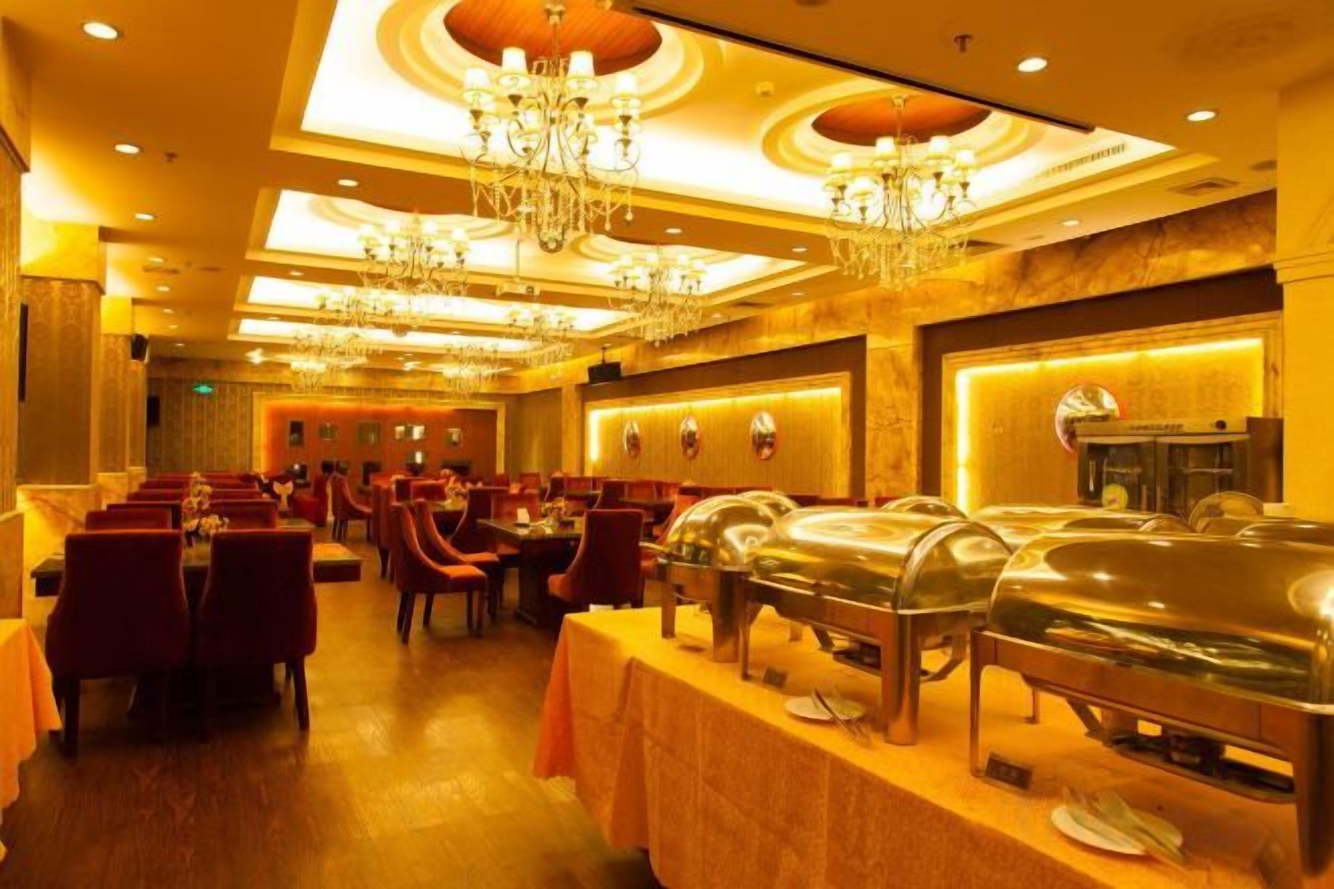 A banquet hall with round tables, chairs, and buffet stations.