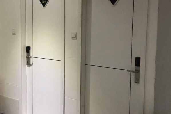 A row of white doors with a horizontal line across the middle, likely indicating a division between rooms. - Gutian Sanyou Business Hotel (Gutian)