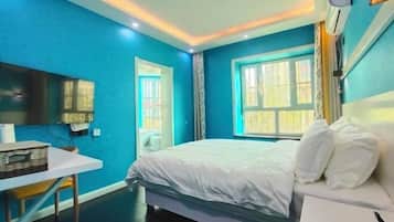 A bedroom with a bed, a bedside table, a chair, a window, and a wall-mounted air conditioning unit.