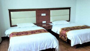 A double room with two beds, each with a headboard and a bedside table. - Yongshun Pinghe Homestay (Yongshun)
