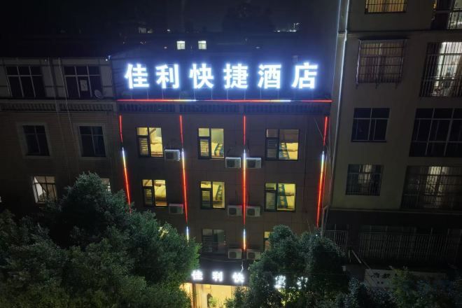 A hotel with illuminated signage, multiple floors, and a visible entrance.