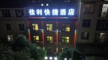 A hotel with illuminated signage, multiple floors, and a visible entrance.