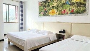 A hotel room with two beds, a large floral painting on the wall, a window with curtains, and a bedside table with a phone. - An Inn (Guilin Yiyuan Branch) (Guilin)