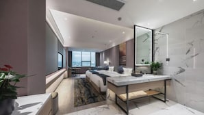A modern hotel room with a large bed, a sitting area, a bathroom with a large mirror, and a view of the city. - haofeng S hotel (Chengdu)