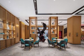 A modern interior with wooden bookshelves, a central sculpture, and seating areas. - haofeng S hotel (Chengdu)