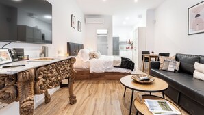 A modern apartment with a large bed, a dining area, a living room, and a kitchen. - "Las Damas de Madrid 10 minutes from downtown" (Madrid)