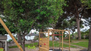 A playground with climbing wall, swings, and a table with chairs. - Apartment in villa with direct access to the sea, suitable for families with children (Sas Linnas Siccas)