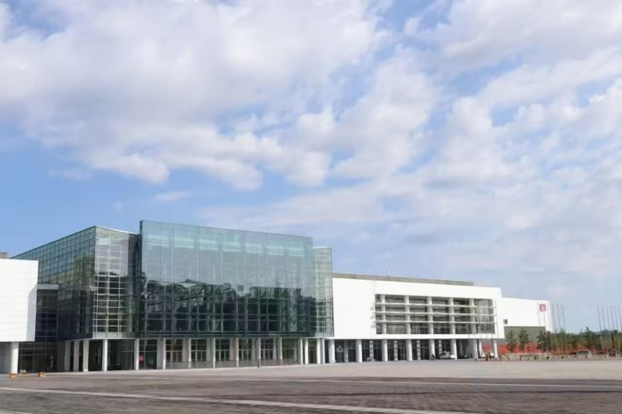 A modern building with a glass facade and a flat roof.