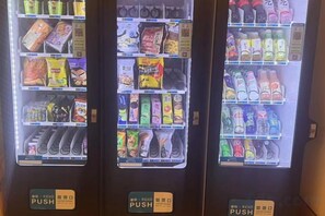 A vending machine with various snacks and drinks. - GreenTree Inn Express Hotel (Beijing)