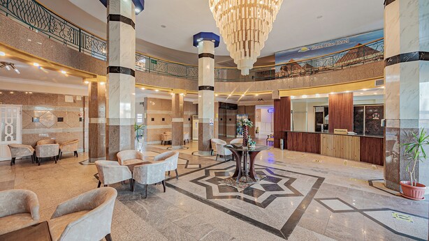 A spacious lobby with marble flooring, a grand chandelier, and multiple seating areas. - Saint Maria Hotel Hurghada (Hurghada)