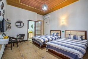 A bedroom with two beds, a desk, a chair, a mirror, and a door. - Anjiyingjun (Anji)