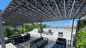 A rooftop terrace with outdoor seating, a pergola, and a city view. - Beautiful Apartment for 4 pax in Caballito With Pool (Buenos Aires)