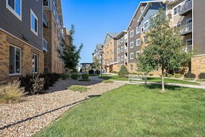 A residential area with multi-story buildings, a paved walkway, and well-maintained grassy areas. - Waterwalk Extended Stay Kansas City - Overland Pk (Overland Park)