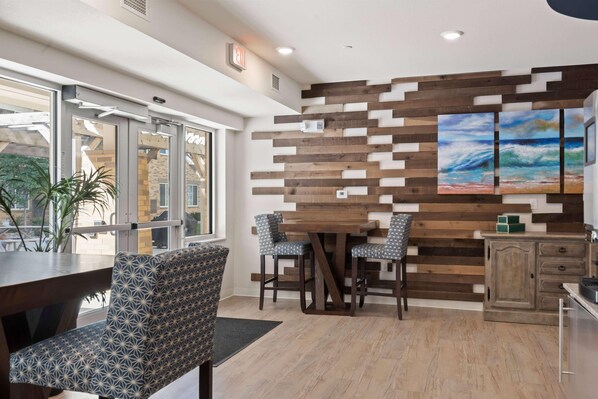Un comedor moderno con una pared de madera, un ventanal y vistas al exterior.