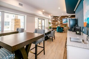 A modern kitchen with a built-in stove, a sink, and a coffee machine. - Waterwalk Extended Stay Kansas City - Overland Pk (Overland Park)