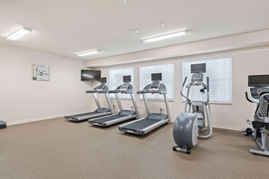 A fitness room with treadmills, an elliptical, and a stationary bike. - Waterwalk Extended Stay Kansas City - Overland Pk (Overland Park)