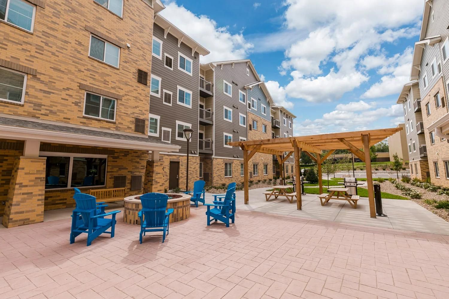 A courtyard with outdoor seating, a barbecue area, and a covered pavilion.