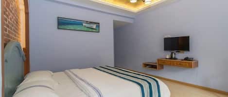 A bedroom with a bed, a TV, a ceiling mural, and a small wooden shelf.